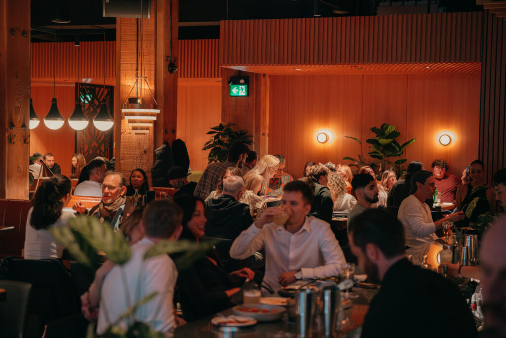 Busy Ray’s dining room with warm lighting and guests enjoying a late-night Yaletown crowd.