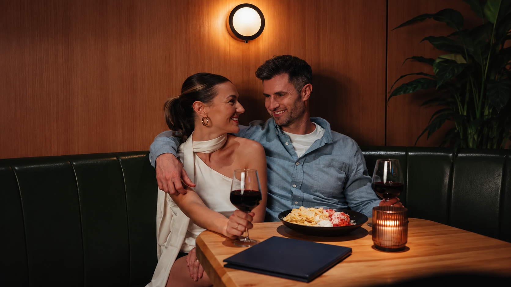 Couple enjoying a romantic dinner with red wine at Ray's restaurant
